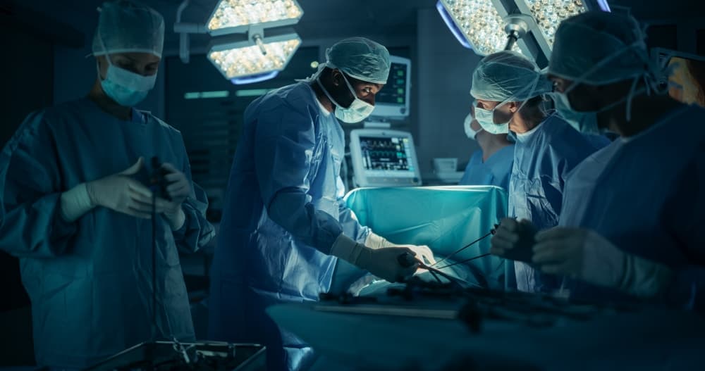 Portrait of a Surgical Team Conducting an Operation in a Dark Hospital Room with Technological Equipment.